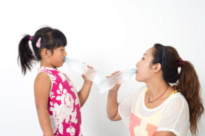 Mother daughter drink mineral water