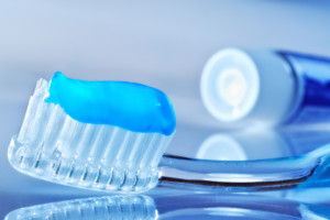 toothbrush on the table with toothpaste and toothpaste tube