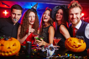 Halloween witches and vampires having cocktail party in bar