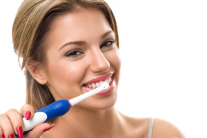 Young beautiful woman brushing her healthy teeth, oral hygiene