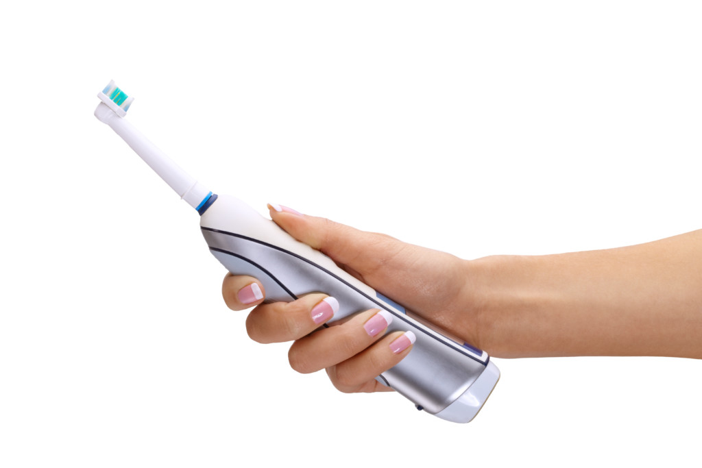 Holiday Gift Ideas - Electronic Toothbrush and woman holding one