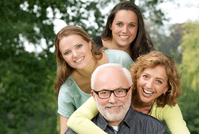 A smiling family show how restorative dentistry can enhance your smile