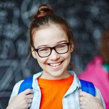 Young girl wearing glasses with blue backpack.